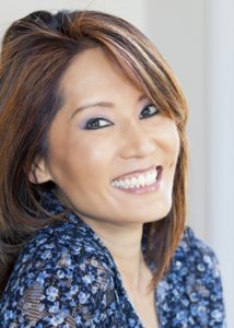 Woman shows off the smile makeover she received from the cosmetic dentists at Stutsman Dentistry.